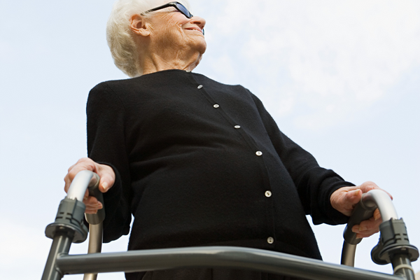 Older lady with walking frame smiling